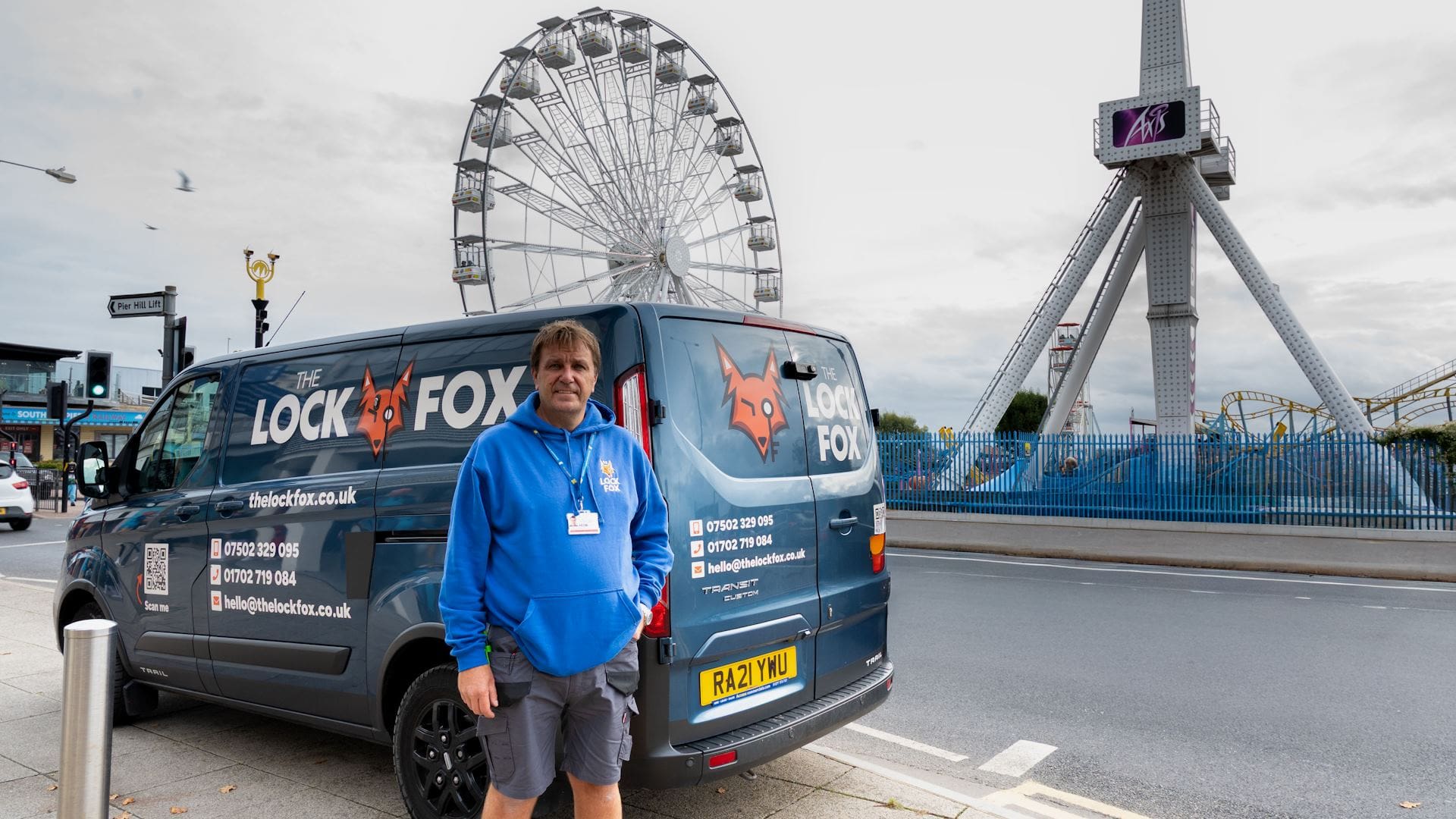 Christian Moore of The Lock Fox beside his branded locksmith van on Southend-on-Sea seafront, with Adventure Island in the background.